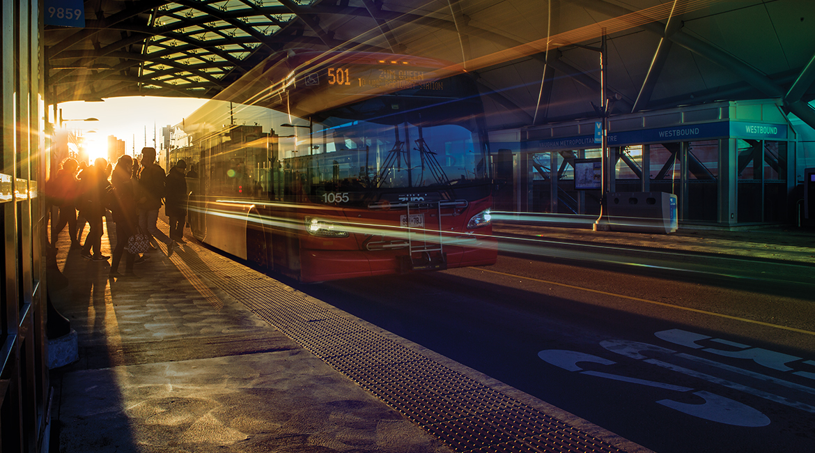 Passengers loading into a bus to support the TOK slogan Transportation. Performance. Technologies.